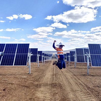 A worker jumps for joy at the Warwick Solar Farm project,